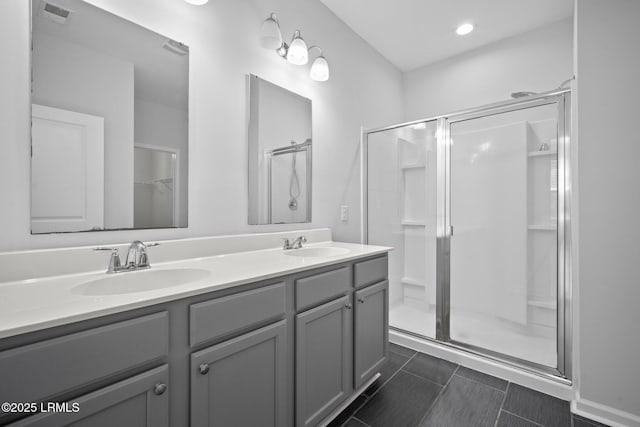 bathroom featuring vanity and an enclosed shower