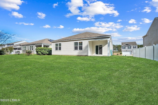 rear view of house with a lawn