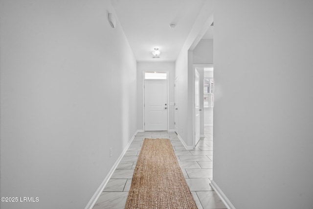 corridor with light tile patterned floors