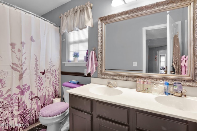 full bath with toilet, double vanity, a sink, and a shower with shower curtain