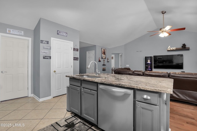 kitchen featuring dishwasher, open floor plan, a sink, and a center island with sink