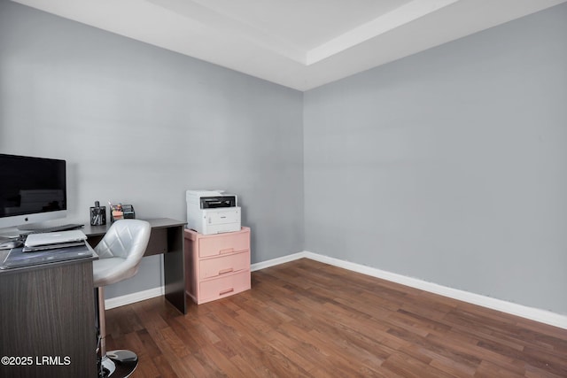 home office with dark wood-type flooring and baseboards