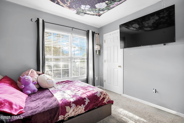 carpeted bedroom featuring baseboards