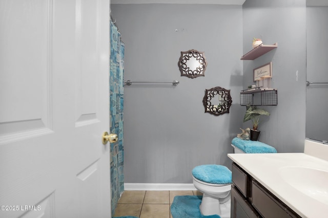 full bath featuring baseboards, vanity, toilet, and tile patterned floors