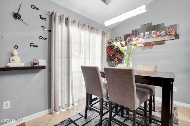 dining room with light tile patterned floors, vaulted ceiling, visible vents, and baseboards