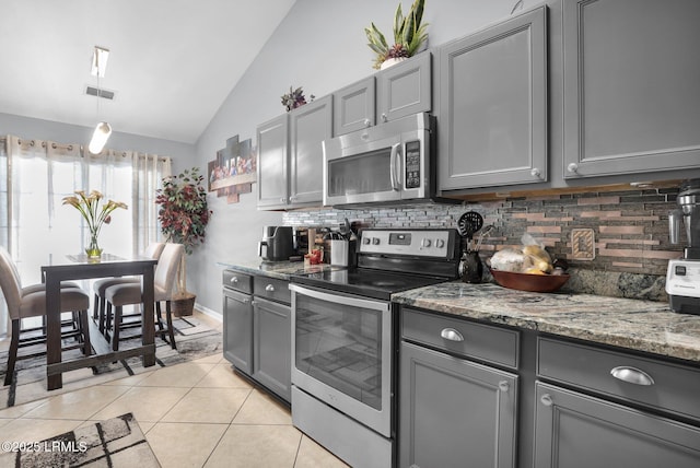 kitchen featuring stainless steel appliances, visible vents, gray cabinetry, and light tile patterned floors