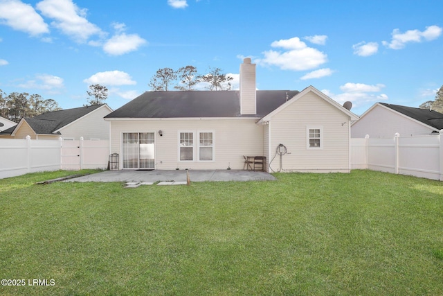 back of property featuring a fenced backyard, a patio, a chimney, and a lawn