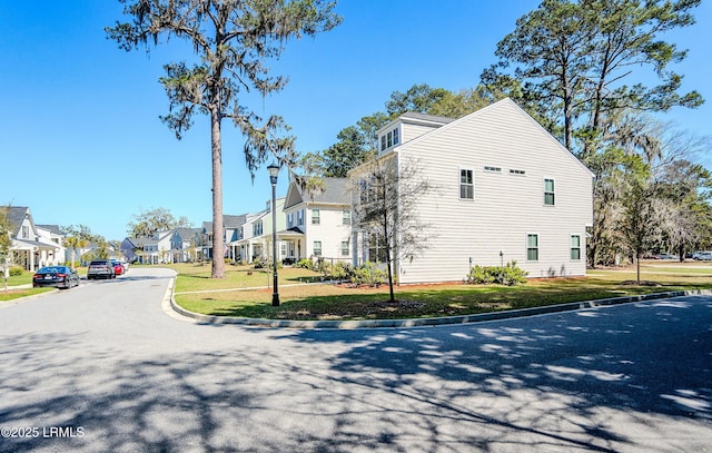 2960 Needlegrass Dr, Beaufort, SC 29902 - view of side of home featuring a lawn and a residential view