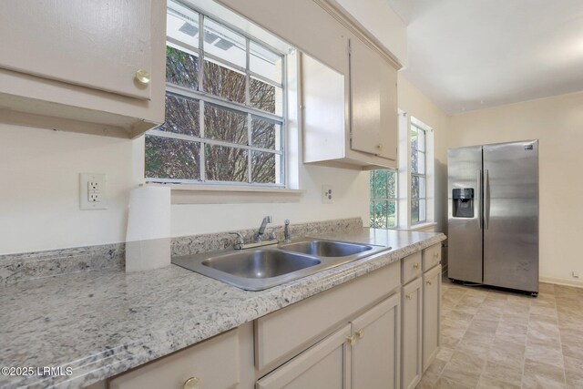 144 Middlefield Cir, Seabrook, SC 29940 - kitchen with a sink, stainless steel fridge, and light countertops