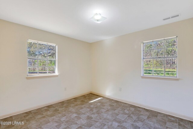 144 Middlefield Cir, Seabrook, SC 29940 - spare room featuring baseboards, visible vents, and a wealth of natural light