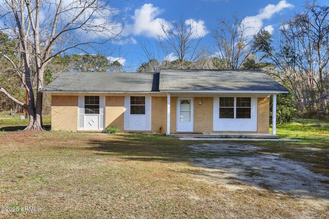 144 Middlefield Cir, Seabrook, SC 29940 - ranch-style house featuring a front lawn, dirt driveway, and a shingled roof