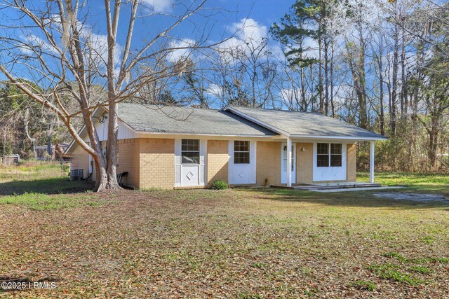 144 Middlefield Cir, Seabrook, SC 29940 - view of front of house featuring brick siding, a front yard, and a shingled roof
