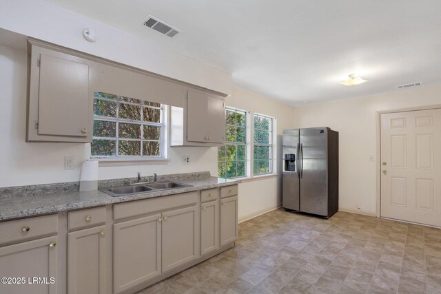 144 Middlefield Cir, Seabrook, SC 29940 - kitchen featuring a sink, visible vents, stainless steel fridge with ice dispenser, and light countertops