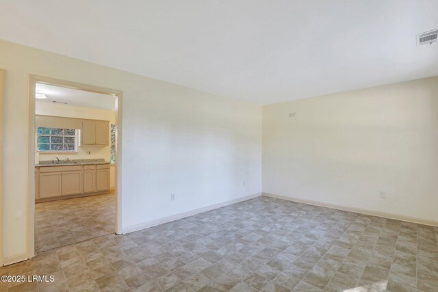 144 Middlefield Cir, Seabrook, SC 29940 - empty room featuring a sink, visible vents, and baseboards