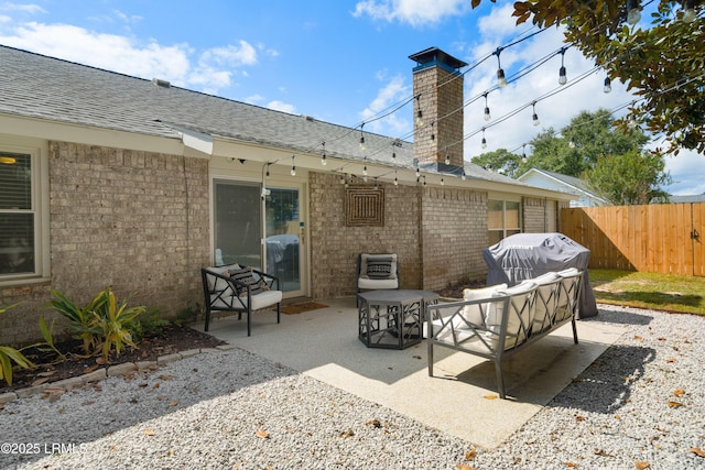 view of patio with an outdoor living space and a grill