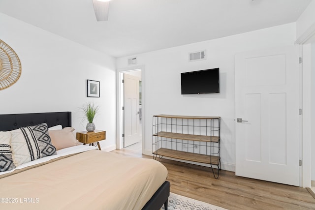 bedroom featuring ceiling fan and light hardwood / wood-style floors