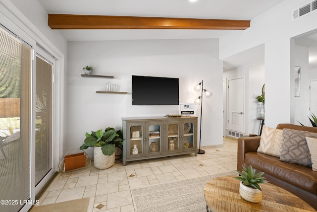 living room featuring beam ceiling and a wealth of natural light