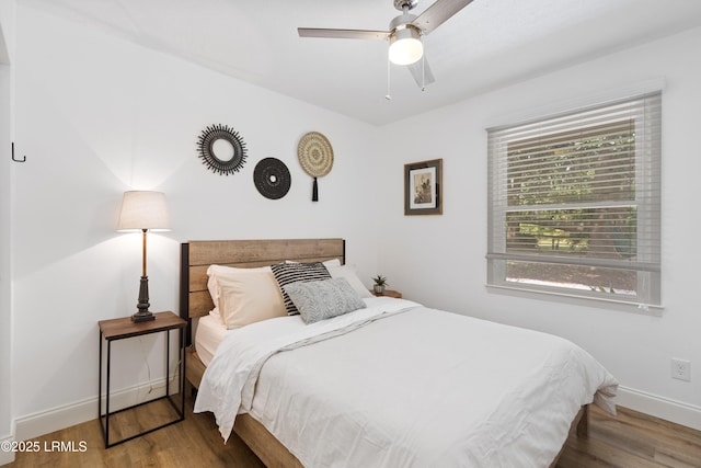 bedroom featuring hardwood / wood-style flooring and ceiling fan