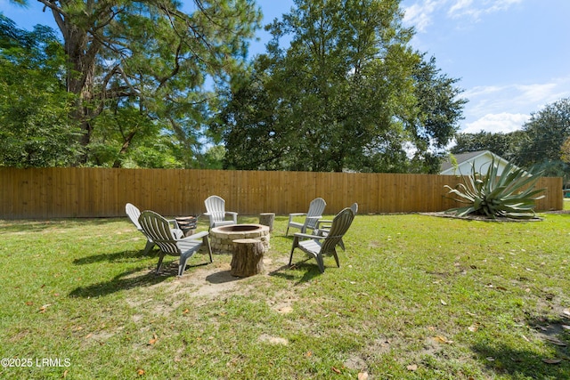 view of yard with a fire pit