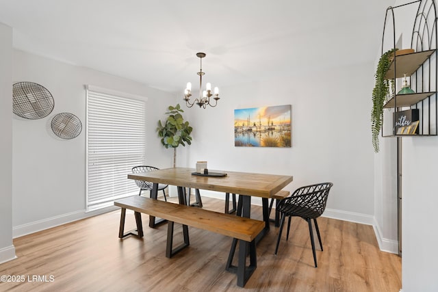 dining room with a notable chandelier and light hardwood / wood-style floors