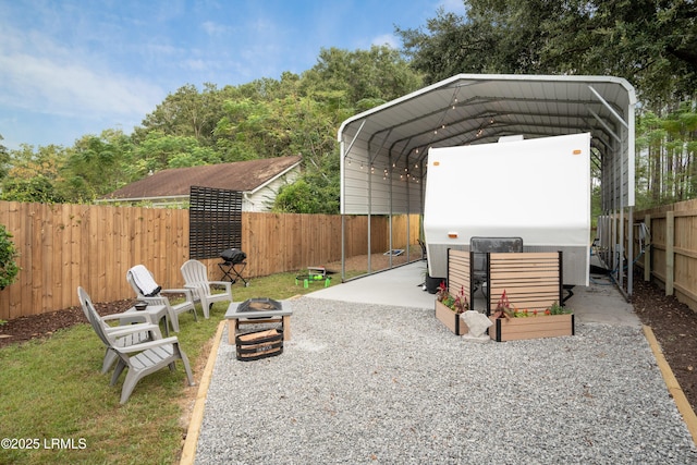 exterior space with a carport and an outdoor fire pit