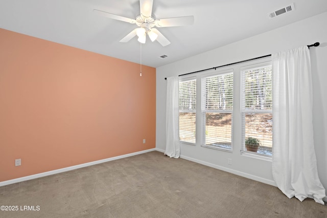 unfurnished room featuring light colored carpet and ceiling fan