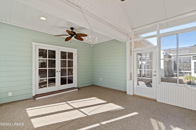 unfurnished sunroom with beamed ceiling, radiator, ceiling fan, and french doors