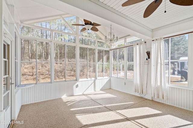 unfurnished sunroom with lofted ceiling, ceiling fan with notable chandelier, and a wealth of natural light