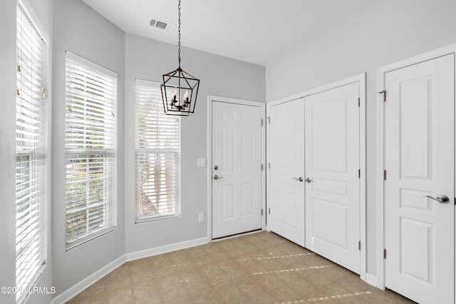 foyer entrance with an inviting chandelier