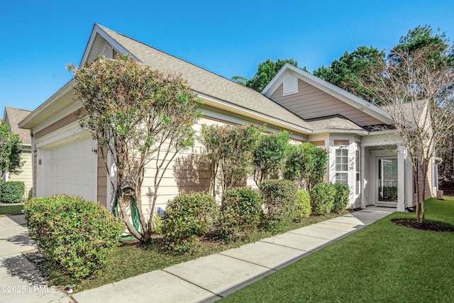 view of front of property featuring a garage and a front lawn