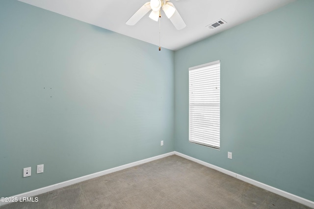 empty room with carpet, a wealth of natural light, and ceiling fan