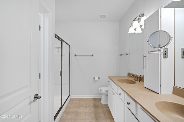 bathroom with vanity, an enclosed shower, and toilet