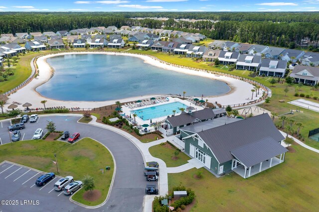 397 Hampton Lake Dr, Bluffton, SC 29910 - aerial perspective of suburban area with a pool, a heavily wooded area, and a nearby body of water