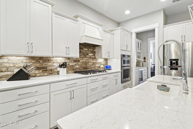 397 Hampton Lake Dr, Bluffton, SC 29910 - kitchen featuring beverage cooler, white cabinets, appliances with stainless steel finishes, decorative backsplash, and light stone countertops