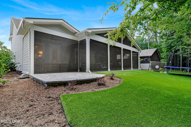 397 Hampton Lake Dr, Bluffton, SC 29910 - rear view of house featuring a sunroom, a trampoline, and a lawn