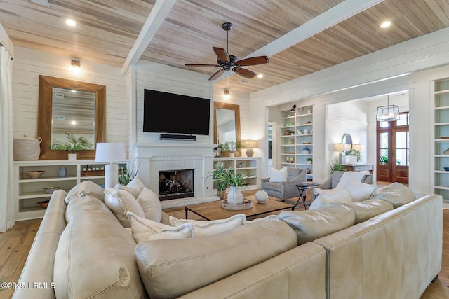 24 Carrier Blf, Bluffton, SC 29909 - living room featuring built in features, wood finished floors, wooden ceiling, ceiling fan, and a fireplace