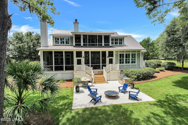 24 Carrier Blf, Bluffton, SC 29909 - back of property featuring a sunroom, a patio area, a chimney, stairway, and a yard