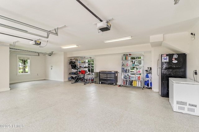 24 Carrier Blf, Bluffton, SC 29909 - garage with a garage door opener, fridge, and freestanding refrigerator