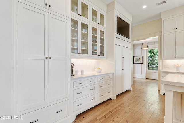 24 Carrier Blf, Bluffton, SC 29909 - kitchen with tasteful backsplash, white cabinets, light wood-style floors, and recessed lighting