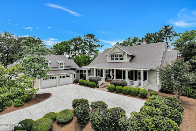 24 Carrier Blf, Bluffton, SC 29909 - view of front of house with covered porch, a metal roof, driveway, and a chimney