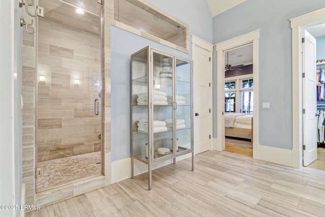 24 Carrier Blf, Bluffton, SC 29909 - bathroom with a shower stall, ceiling fan, connected bathroom, wood finished floors, and lofted ceiling