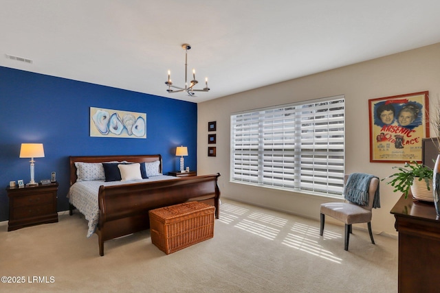 bedroom with visible vents, a notable chandelier, and carpet flooring