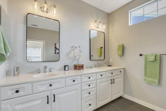 full bath featuring tile patterned flooring, visible vents, double vanity, and a sink