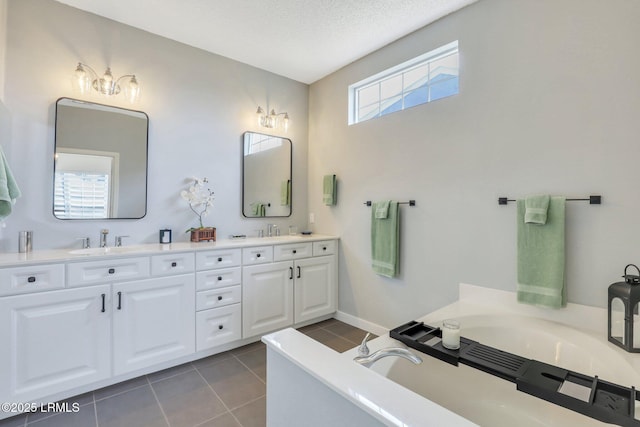 full bathroom featuring a sink, a bath, double vanity, and tile patterned floors