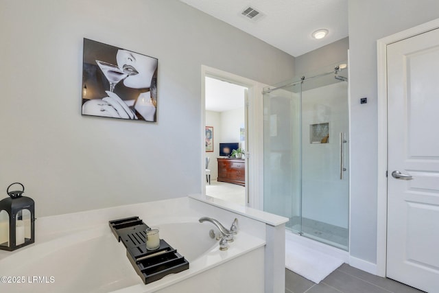 full bath with tile patterned flooring, visible vents, a shower stall, a garden tub, and a textured ceiling