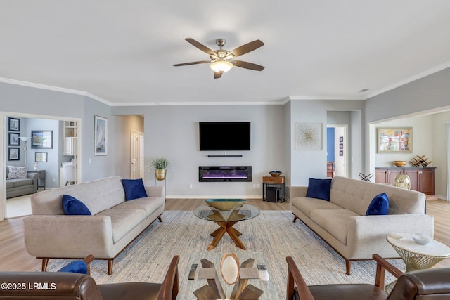 living area with light wood-type flooring, ceiling fan, and ornamental molding