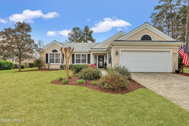 ranch-style home with a garage, stucco siding, decorative driveway, and a front lawn