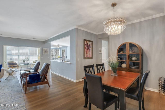 dining room with baseboards, dark wood-style flooring, and crown molding