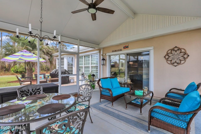 sunroom with lofted ceiling with beams and a ceiling fan