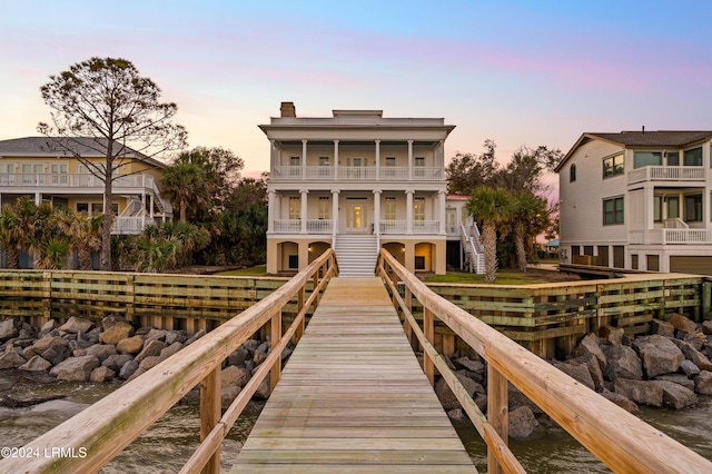 view of dock with a water view and a balcony